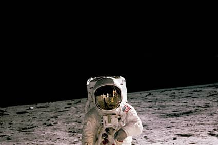 astronaut standing on gray sand