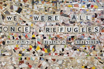 we were all once refugees text on multicolored ceramic tile