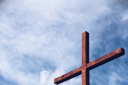 a brown wooden cross - The Christian March To Power In America