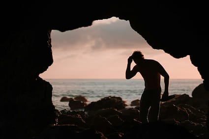 silhouette of man in cave